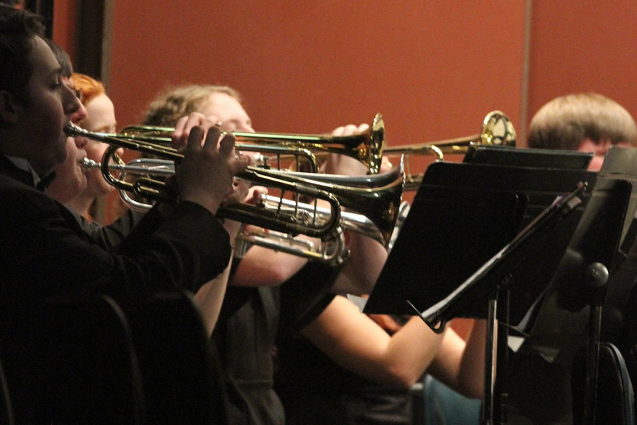 The trumpet section hold their horns high during their first piece. (Pictured: Symphonic Band High Brass)