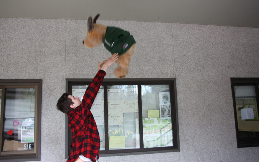 Daniel Fendel tossing a pup in the air like it is a child.