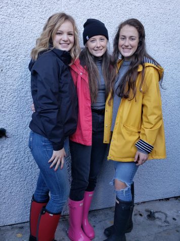 Elyse Donley, Julia Klumker, and Maeve Griffin show off their rain gear for Rainy Day