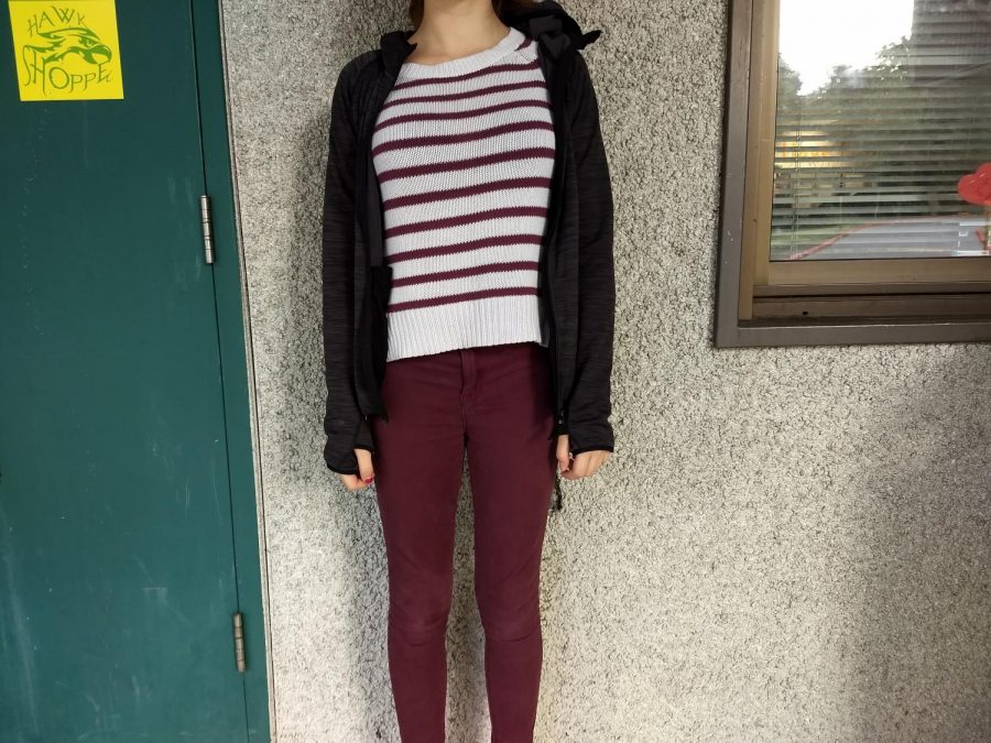Victoria rocking a striped sweater and burgundy jeans.