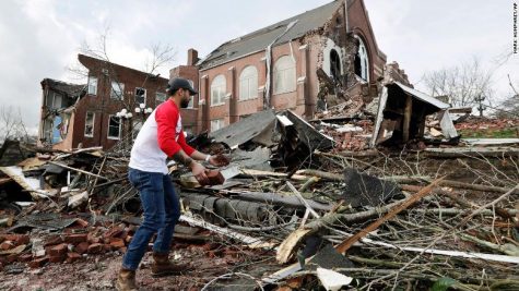 Resident helps to clean up rubble at the East End United Methodist Church after it was heavily damaged by storms Tuesday, March 3, 2020, in Nashville, Tennessee 
(AP Photo/Mark Humphrey)